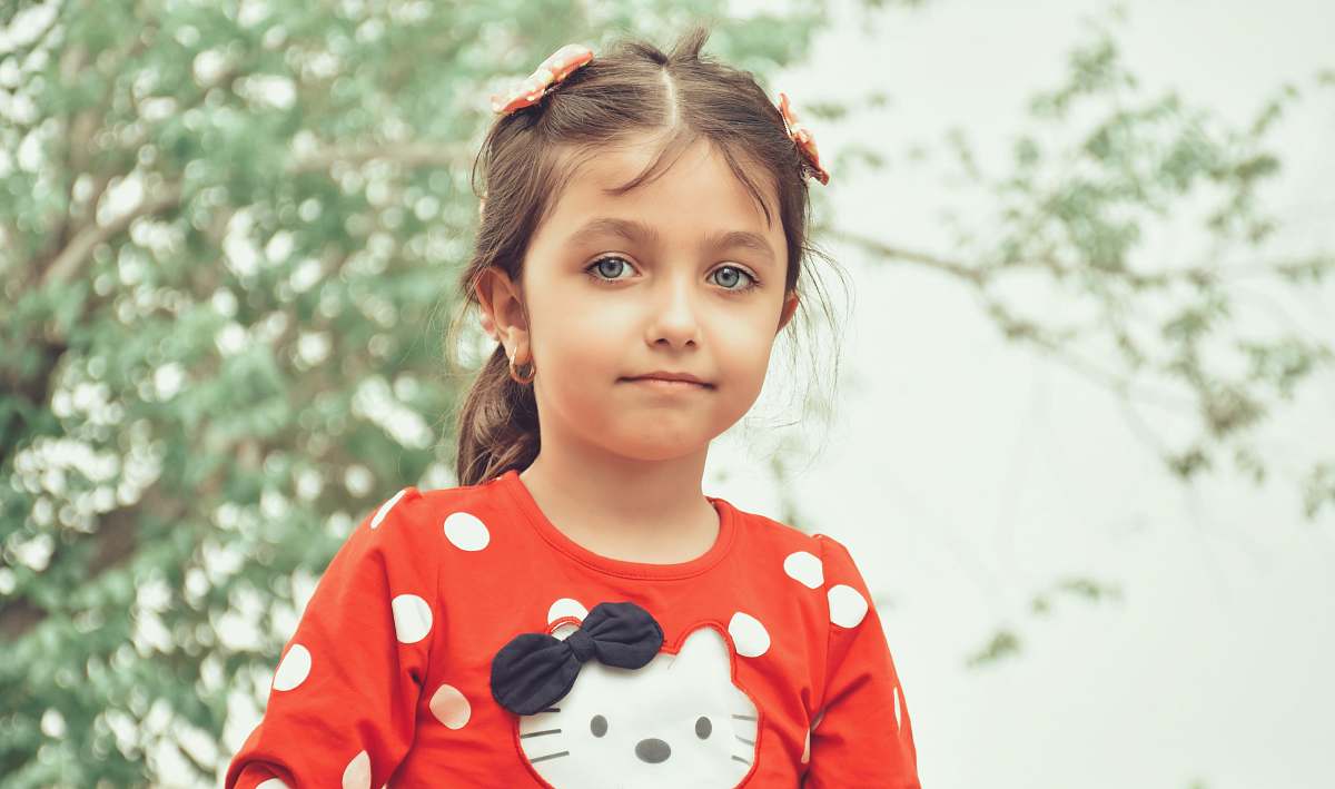 human girl in red and white mickey mouse long sleeve shirt person