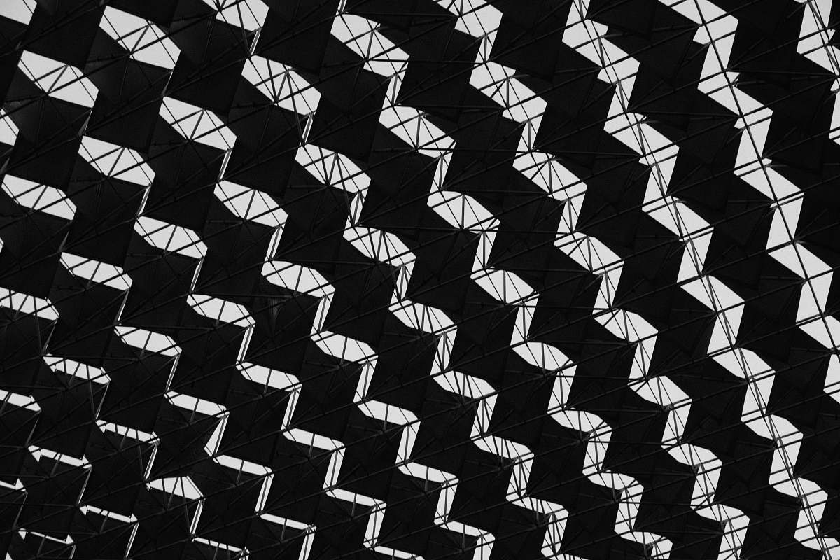 black-and-white low-angle photography of black interior building pattern
