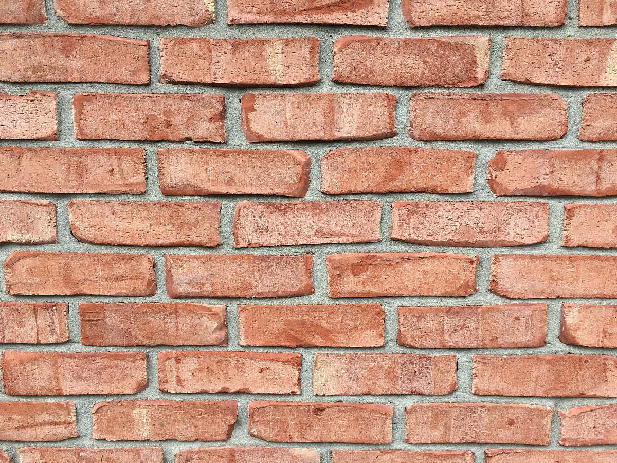 brick red brick wall during daytime house