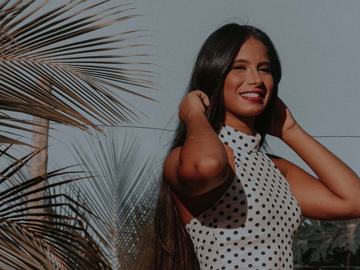 human smiling woman touching her hair with both her hands person