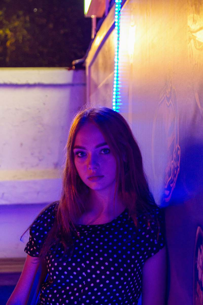 human woman leaning on wall person