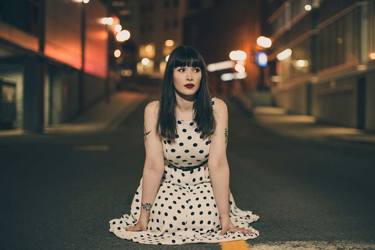 human woman wearing white and black polka-dot dress person