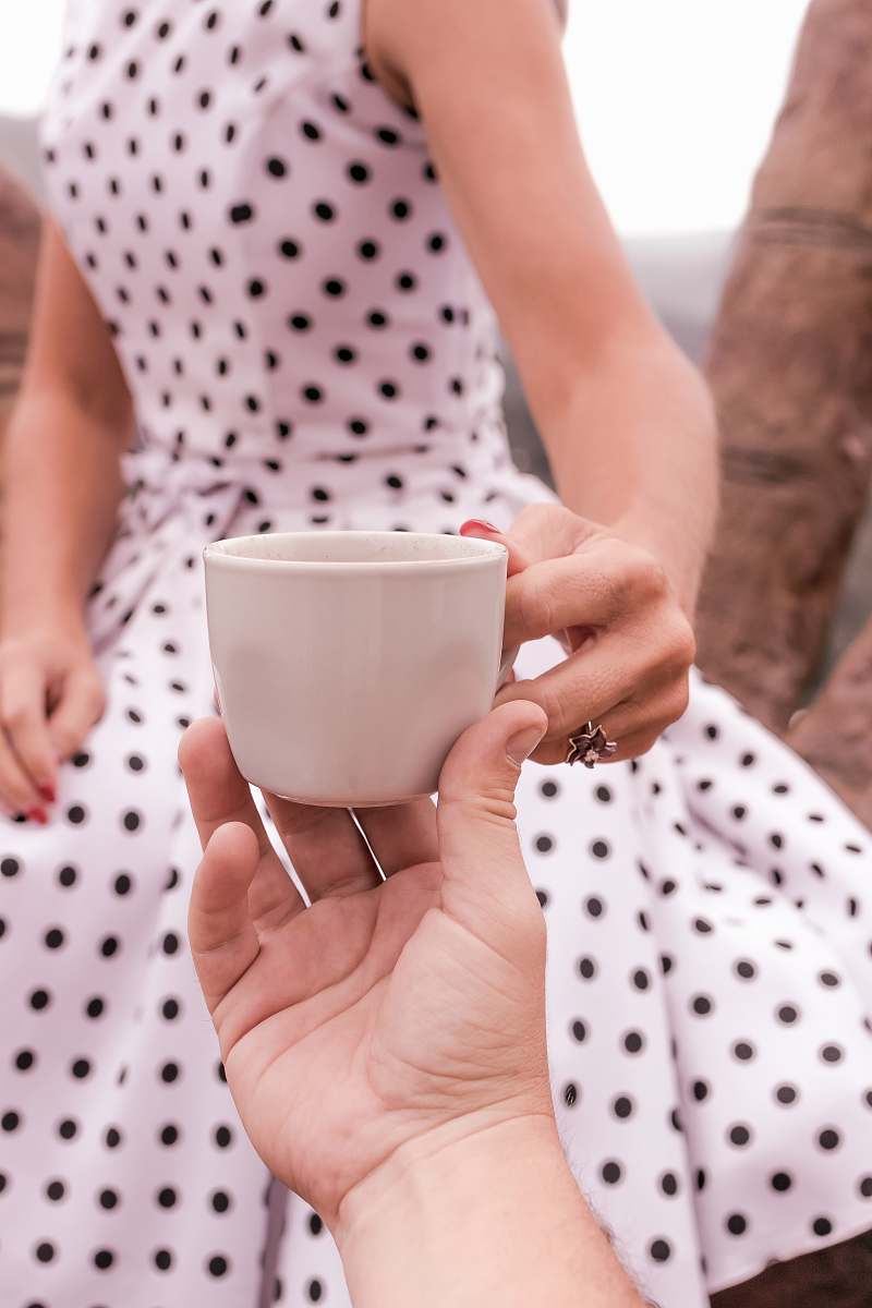 human women;s white polka dot dress close-up photography person