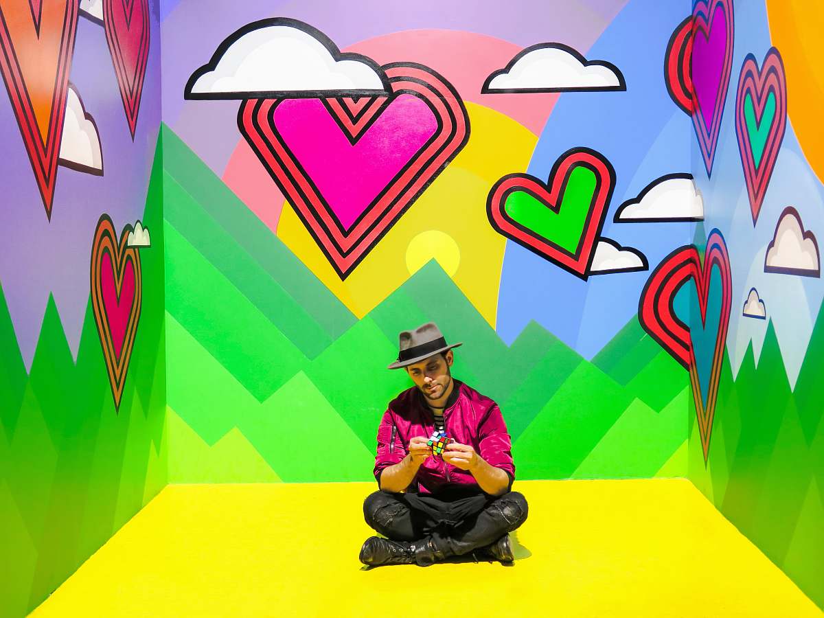  man sitting on multicolored 3D wallpaper room 