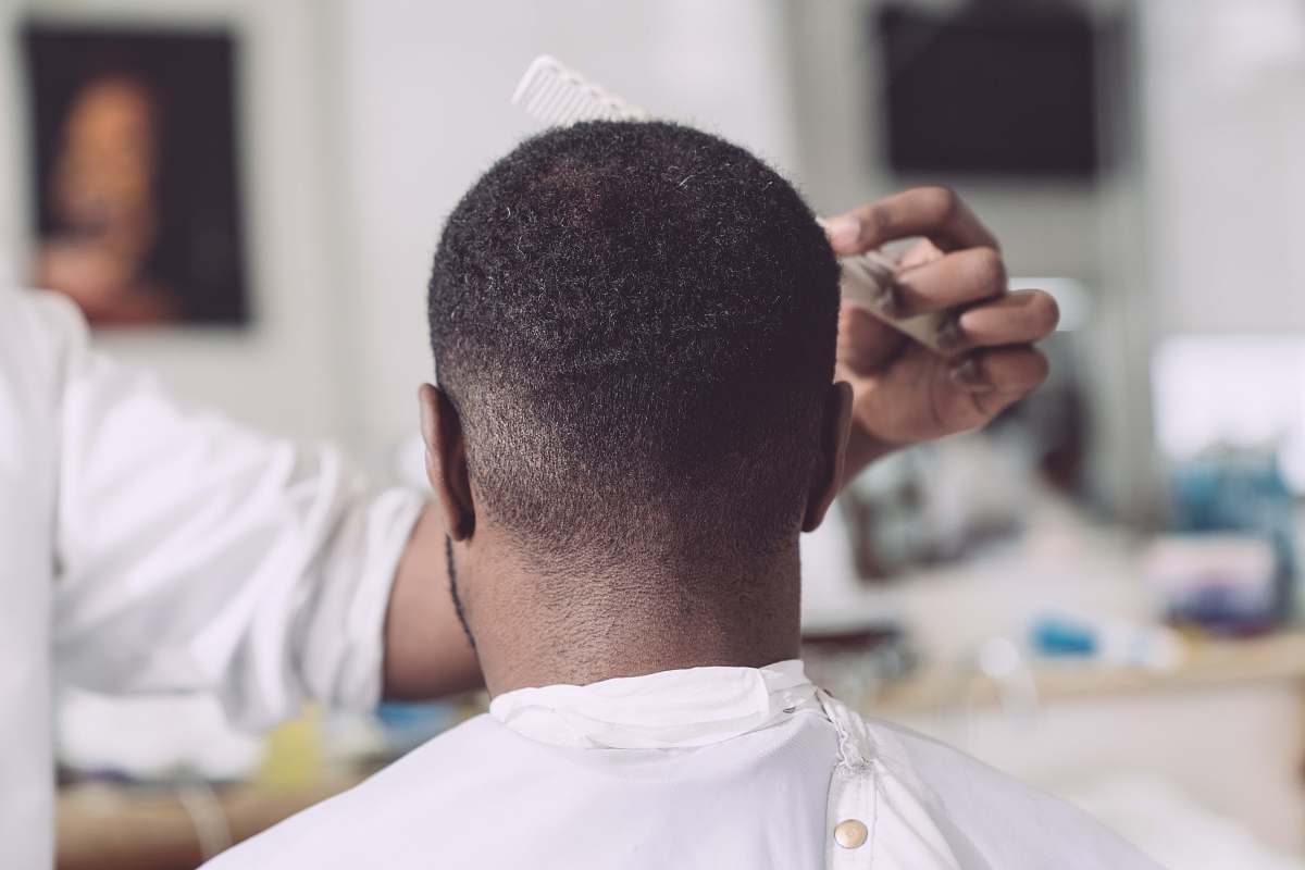  person fixing man's hair 