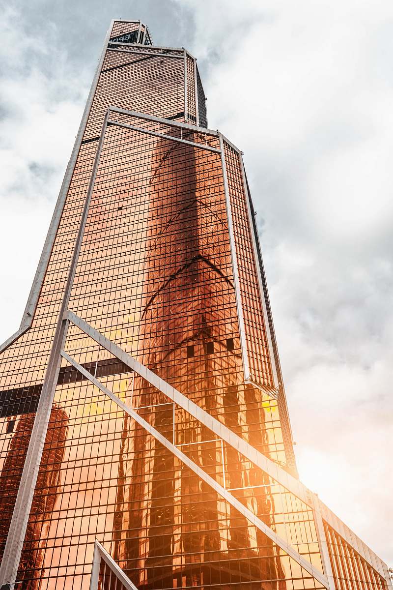 tower gold high-rise building under cloudy sky building