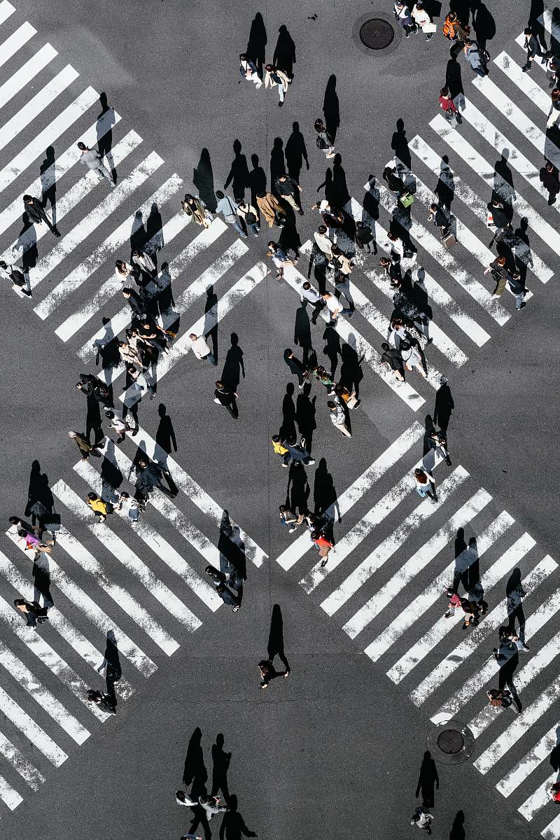 tarmac aerial view of people walking on cross pedestrian lane road