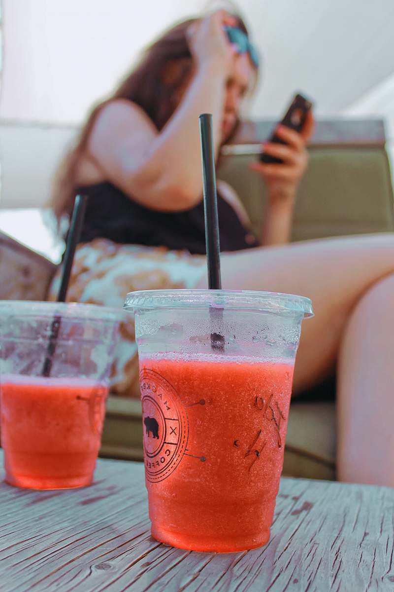 drink women's black top and white shorts juice