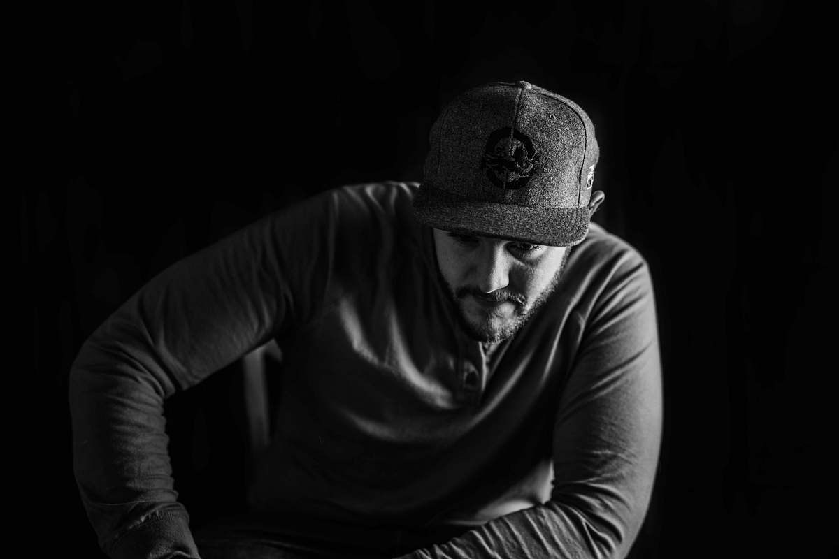 person grascale photography of man sitting face