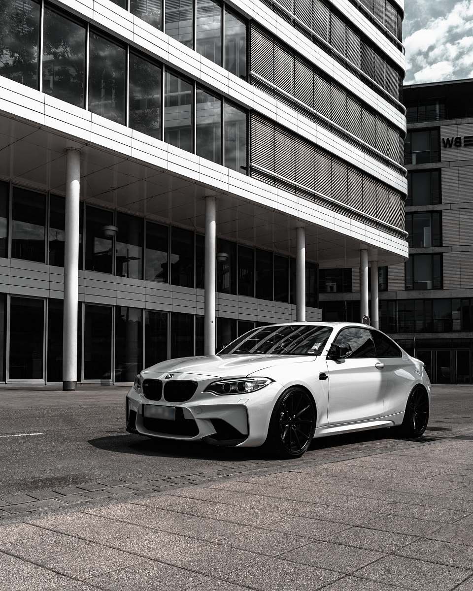 vehicle grayscale photography of BMW coupe in front of building car