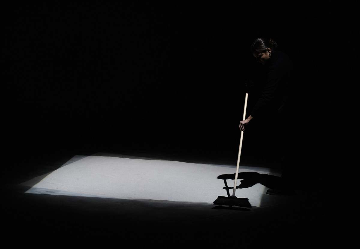 grey man holding rod la biennale di venezia arsenale