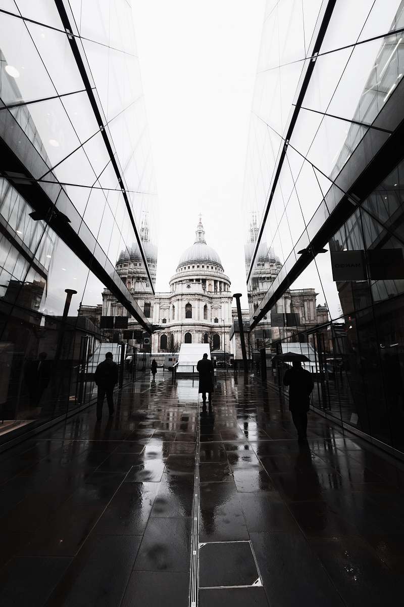 london three person walking on street sidewalk