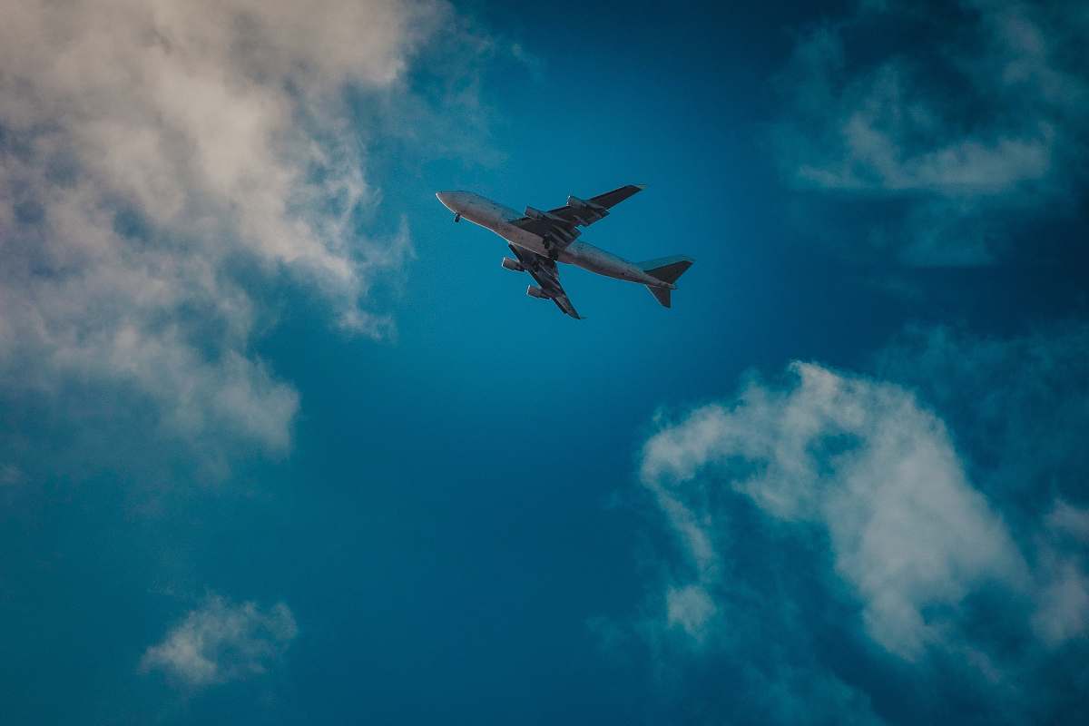 airplane white airplane under blue and white cloudy sky aircraft