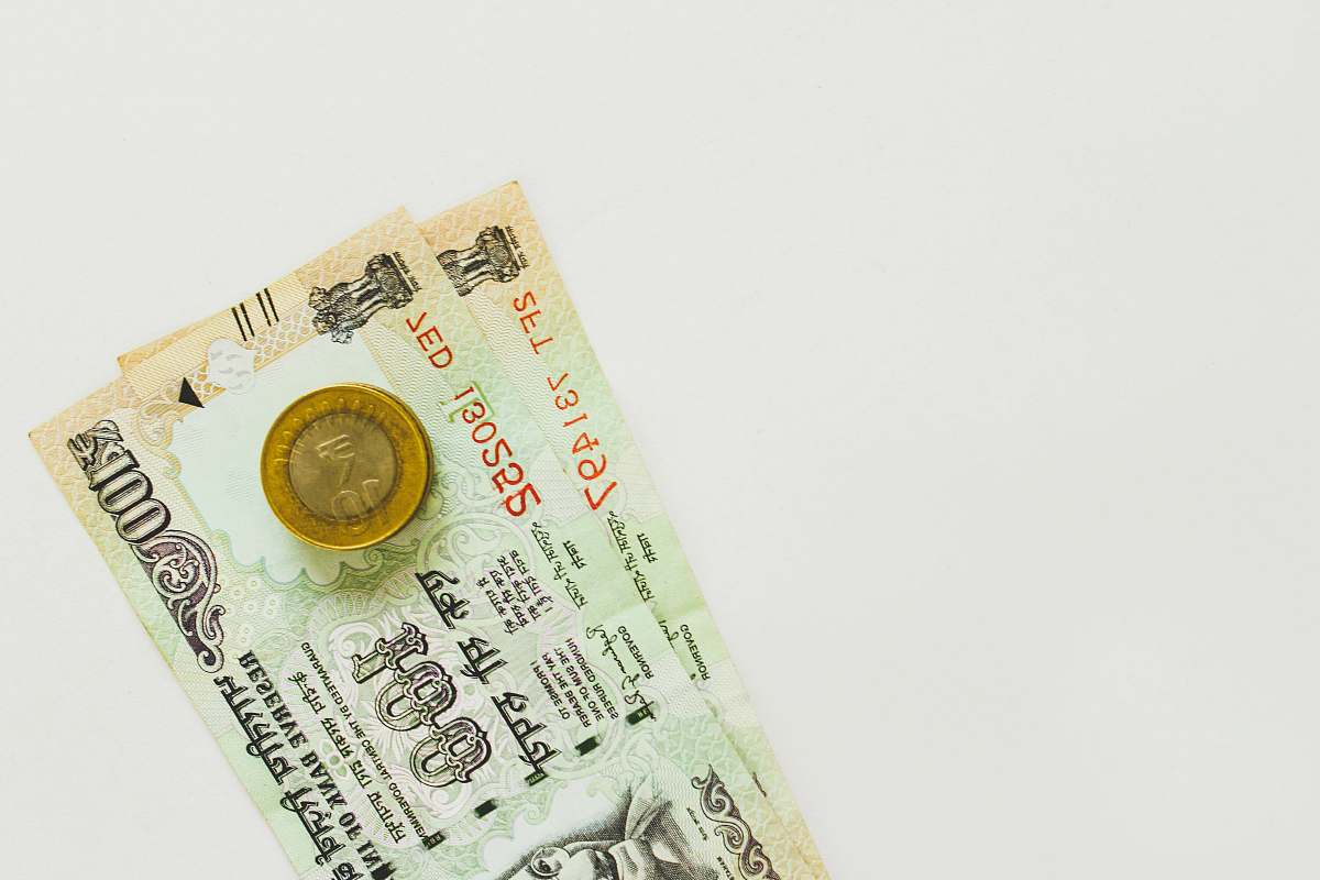 coin 100 Indian rupee banknote dollar