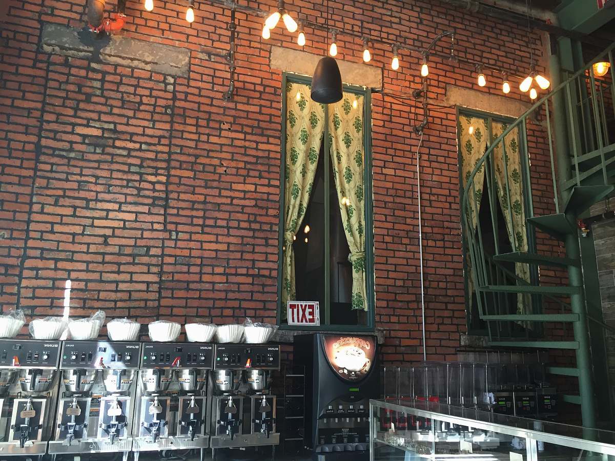 background brown brick wall with exit signage exit sign