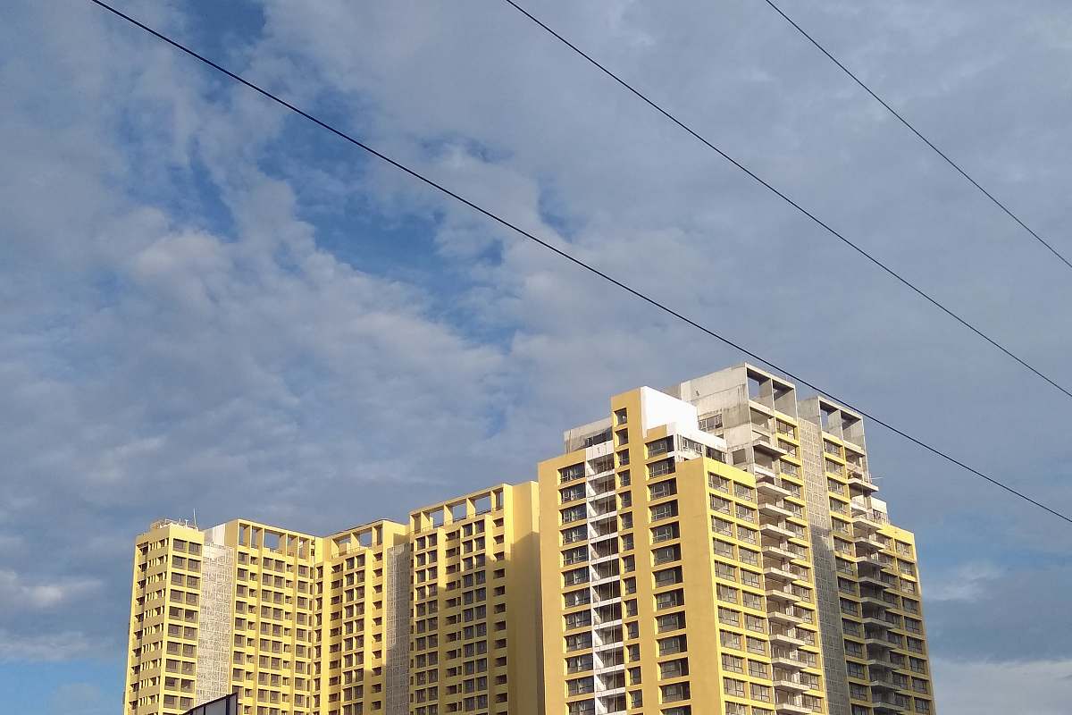 city beige multi-story building under cloudy sky high rise