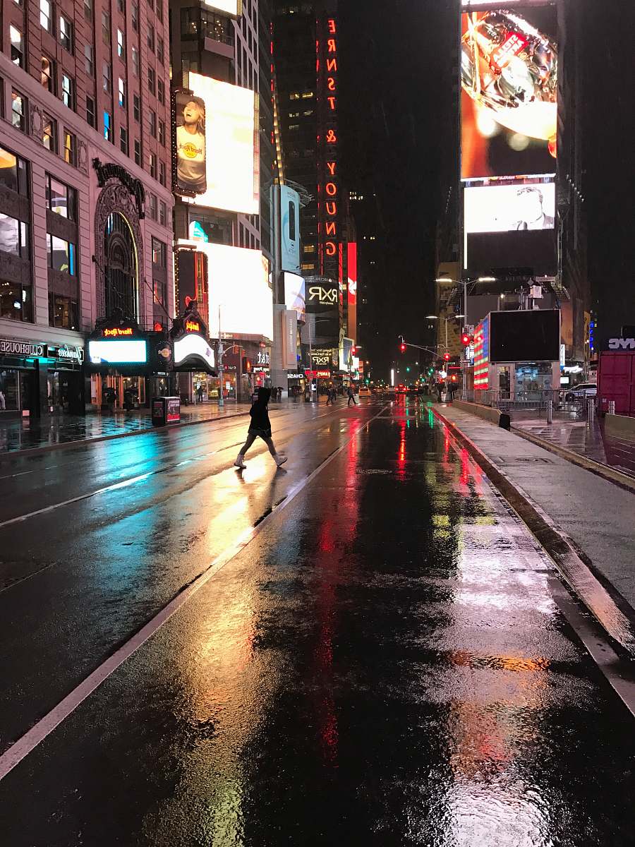 city black concrete road near high buildings at nighttime downtown