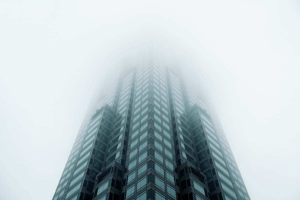 architecture black high-rise building covered with fog skyscraper