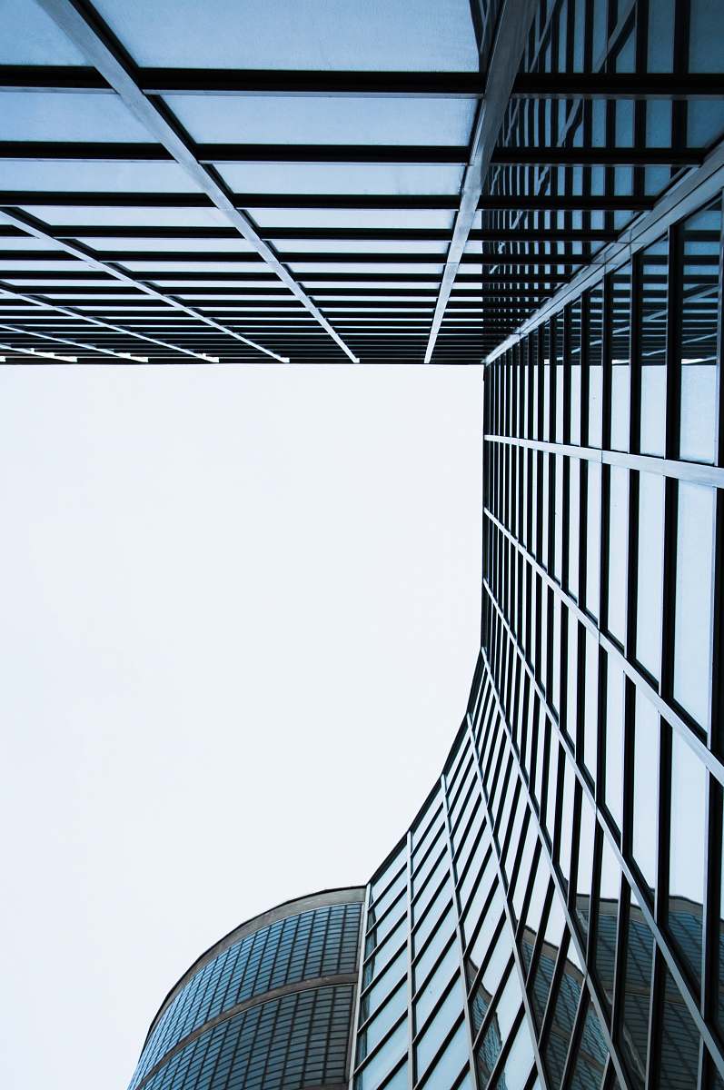 city blue concrete building during day time skyscraper