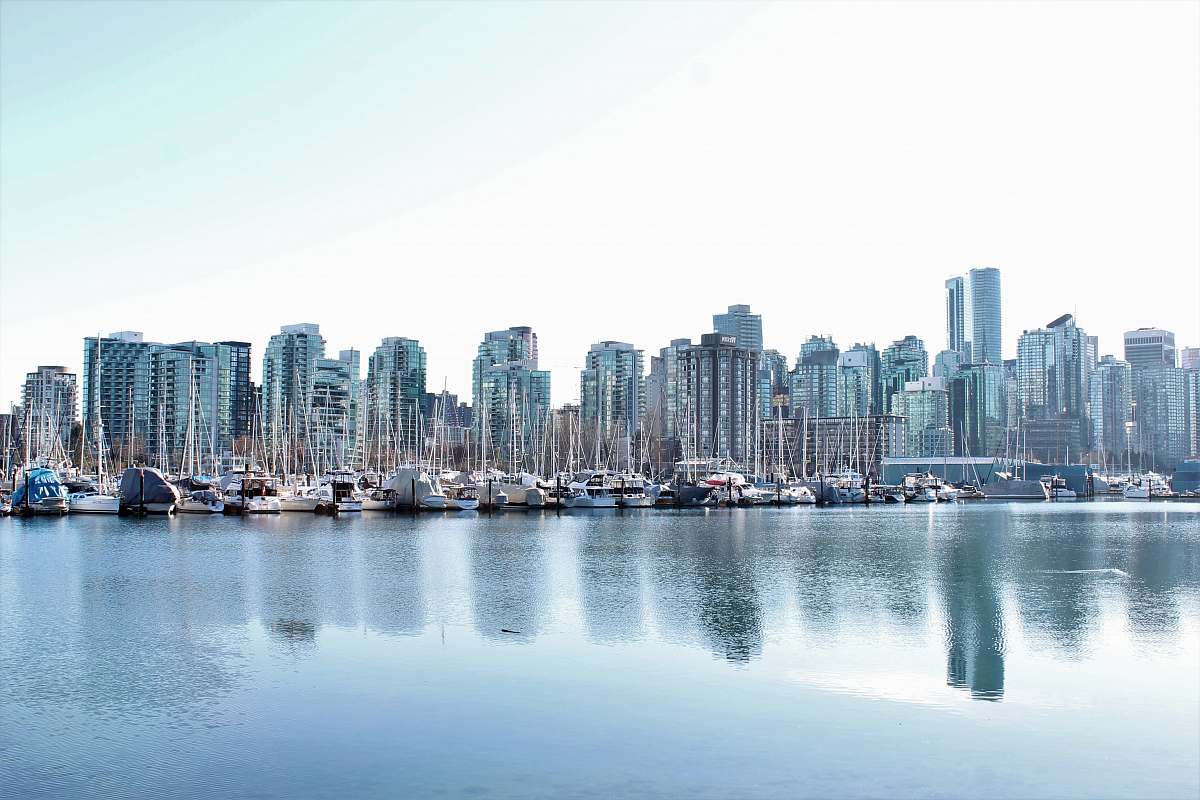 city body of water near high buildings at daytime town
