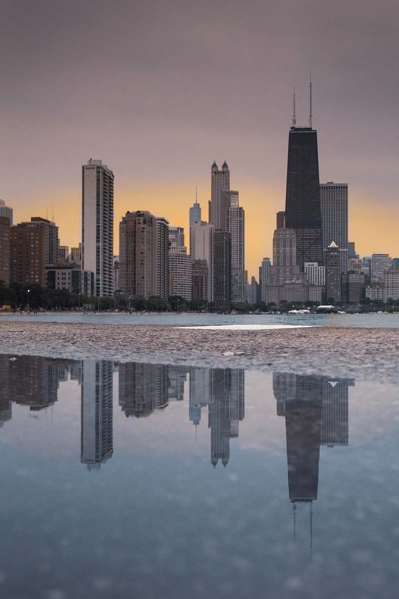 city buildings near ocean at daytime high rise
