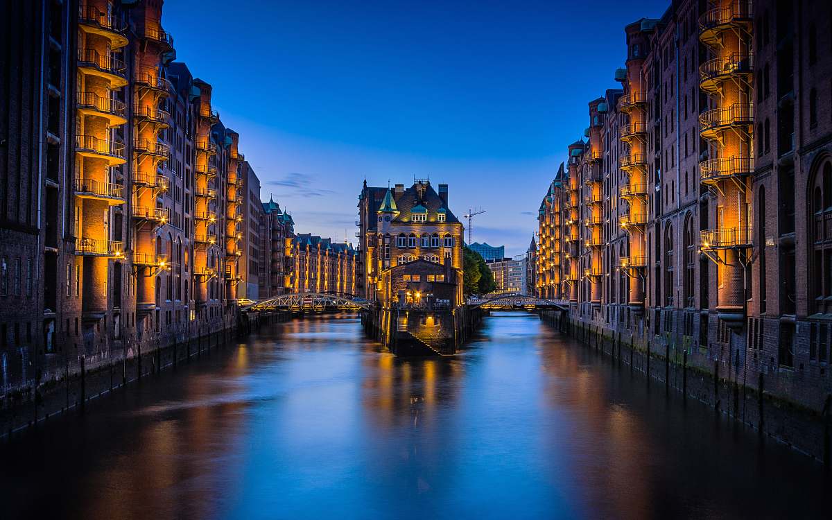 hamburg canal between buildings during nighttime germany