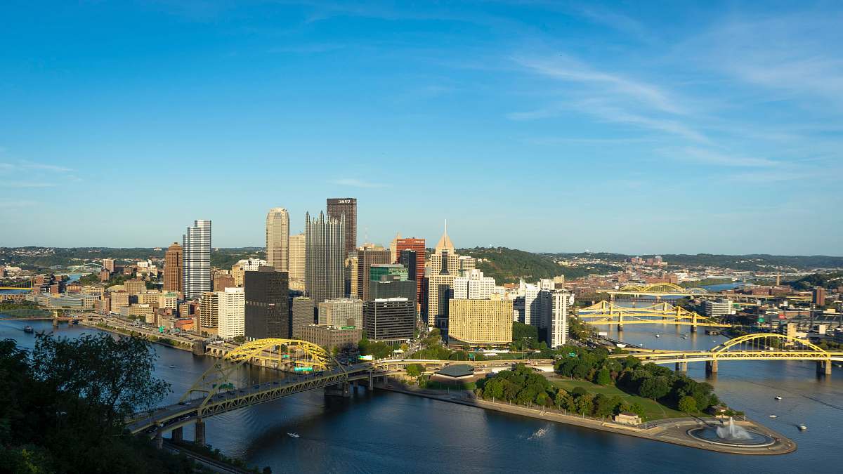 city city with high-rise building viewing blue sea under blue and white skies during daytime town