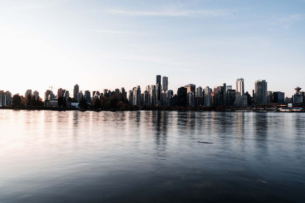 city cityscapes near body of water high rise