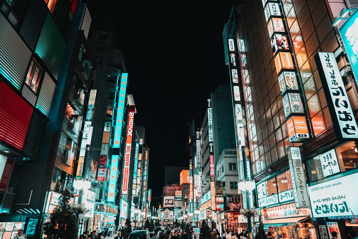 city crowd of people in the streets of a city during nighttime downtown