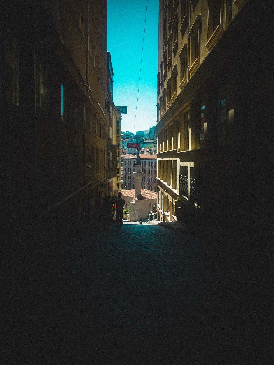 city dark walkway between buildings road