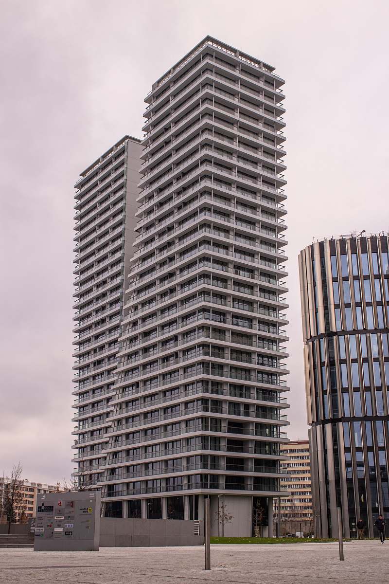 condo gray and white building under white cloud housing