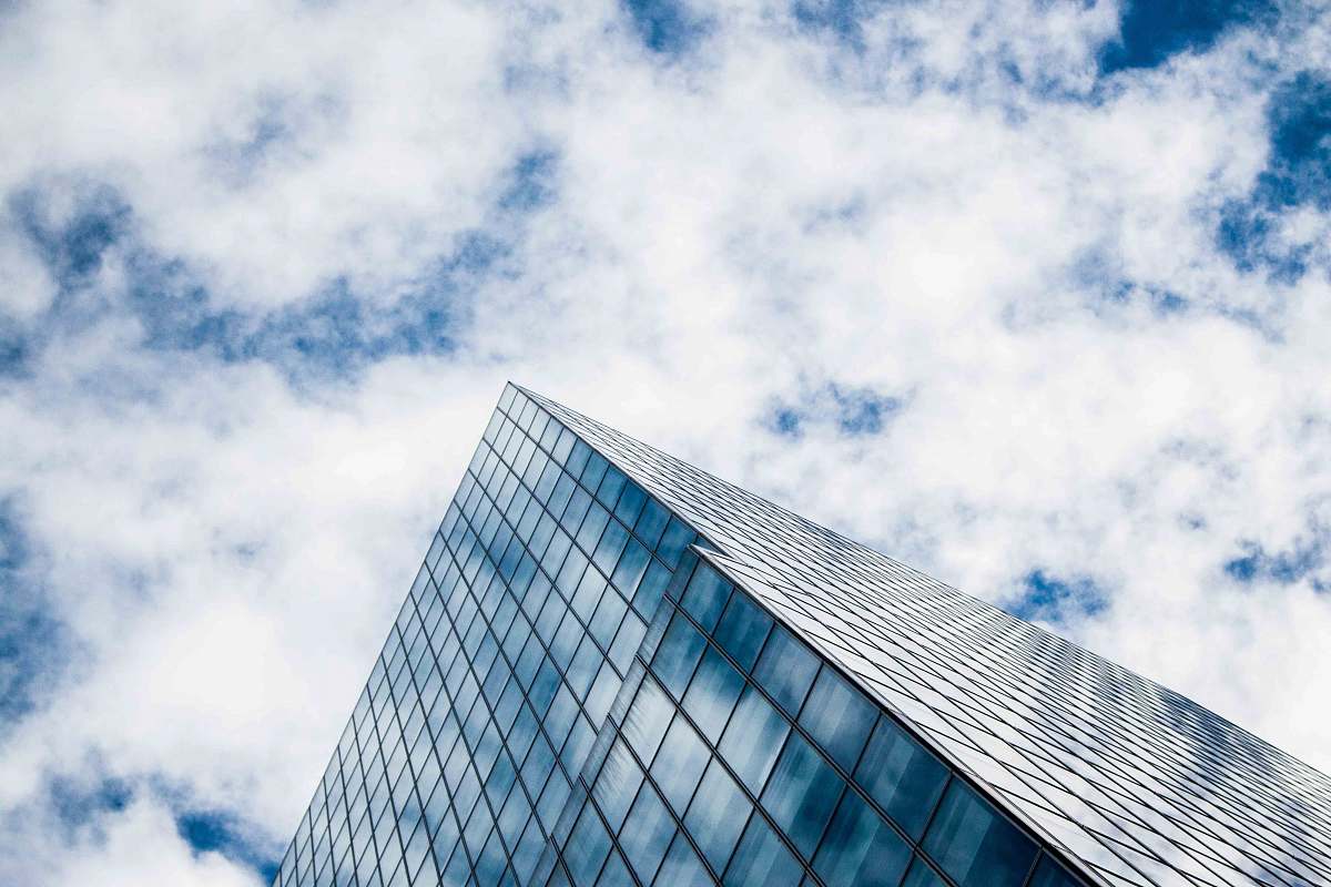 clouds gray concrete building under blue sky city