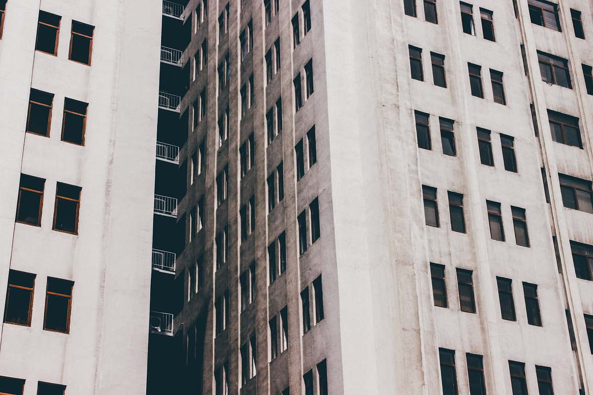 city gray concrete building with windows urban