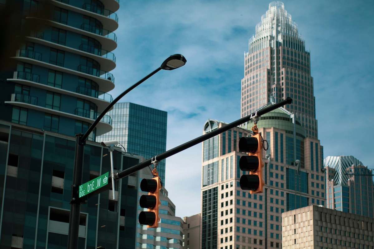 light gray concrete buildings during daytime traffic light