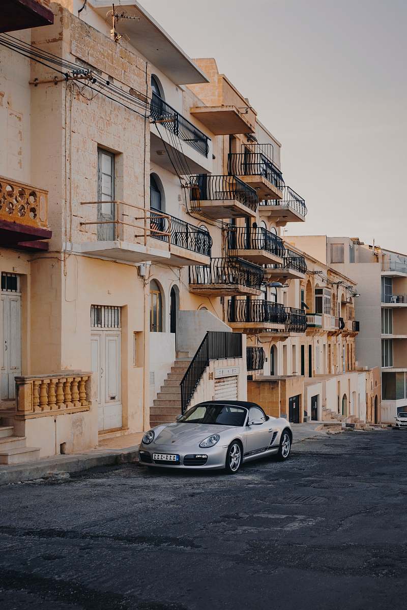 city gray convertible coupe apartment building