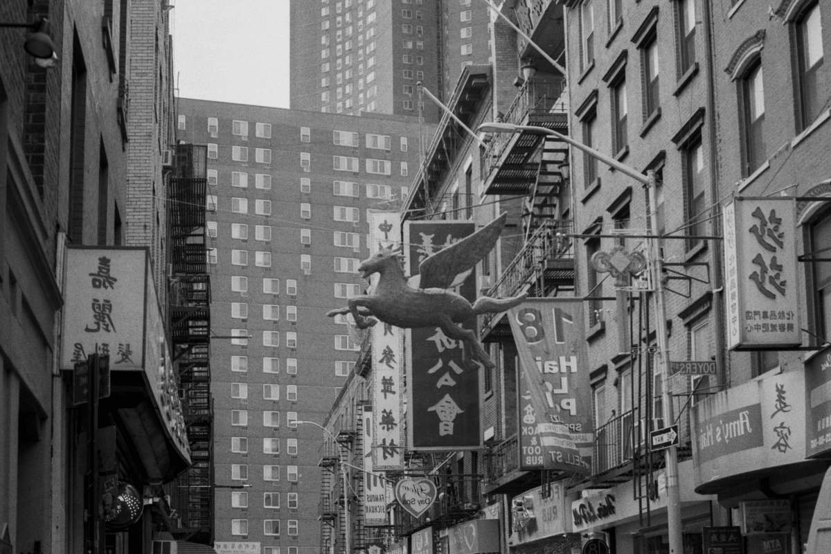 city grayscale photo of store signage black-and-white