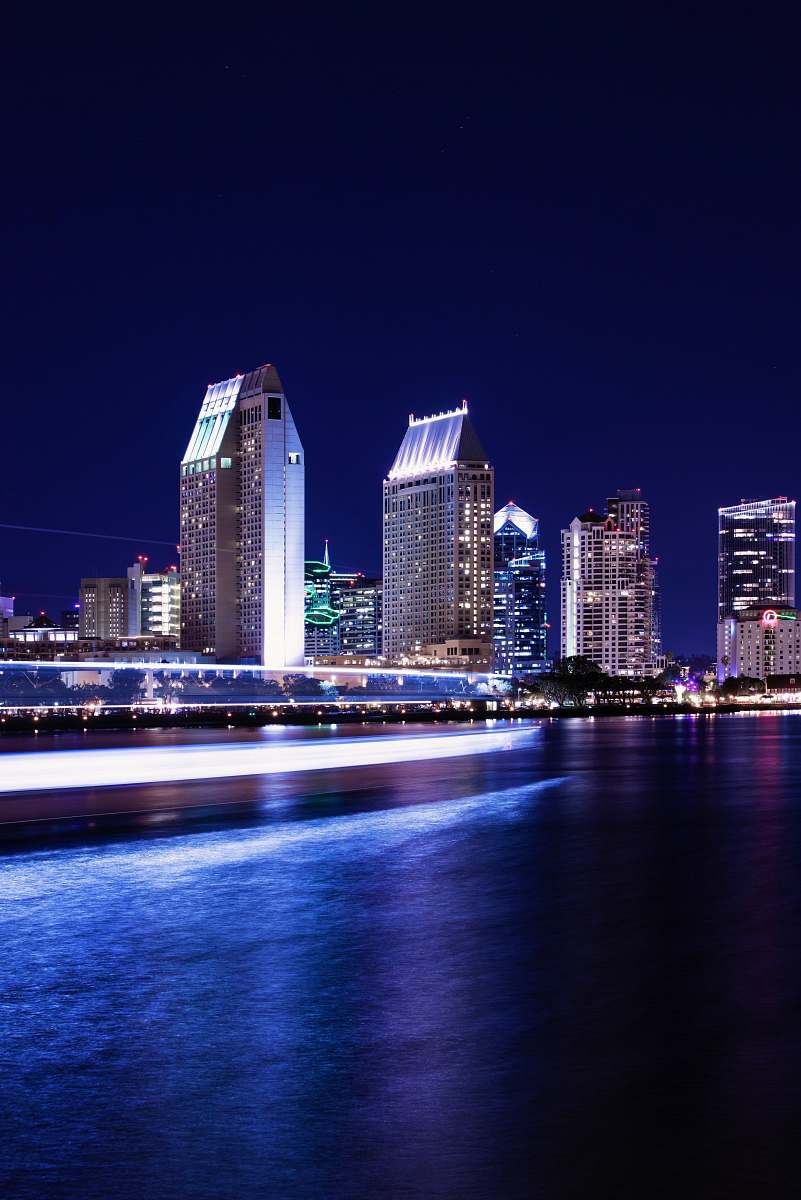 city high rise building near body of water during daytime town