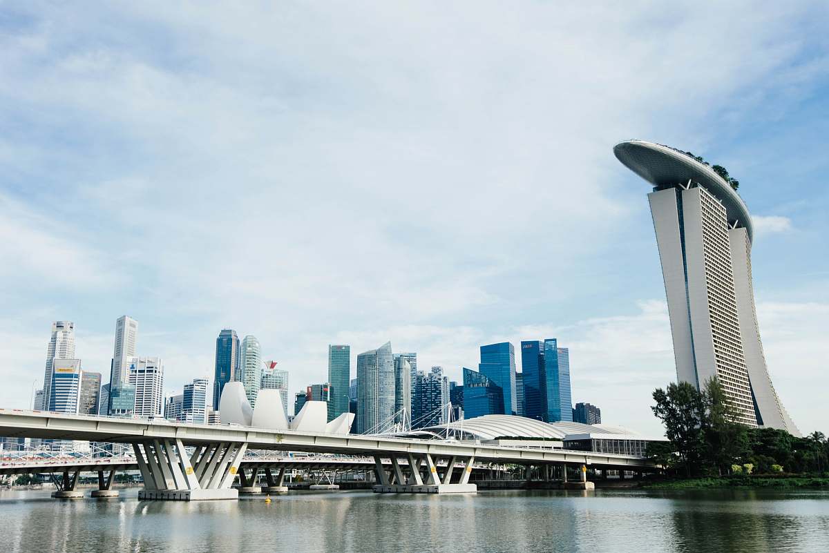 city landscape photography of concrete structures near body of water urban