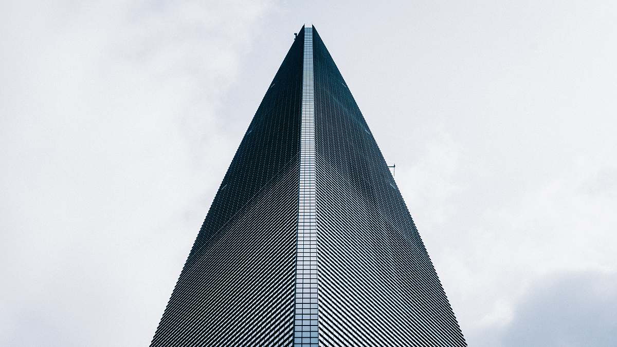 city low angle photo of curtain glass wall building high rise