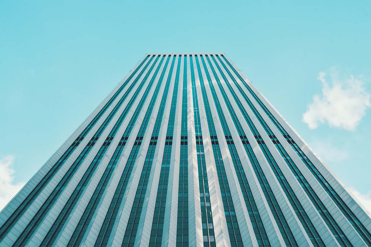 city low-angle photography of blue building office building