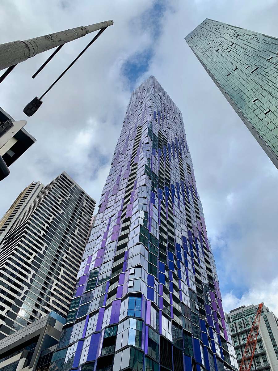 Experience the grandeur of urban architecture with this captivating low-angle photograph of towering skyscrapers. This high-rise cityscape showcases the impressive designs and scale of modern buildings, making it an ideal image for real estate marketing, city guides, and architectural portfolios. Perfect for adding a dynamic touch to business presentations or as a striking backdrop for web design.