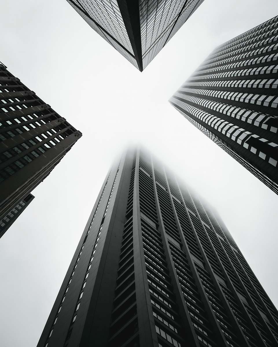 town low angle photography of four high-rise buildings black-and-white