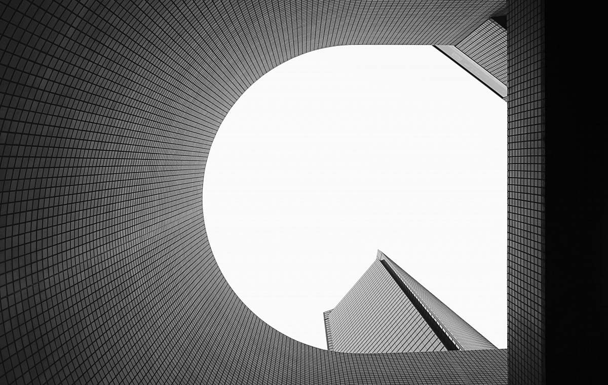 city low angle photography of gray high-rise building black-and-white