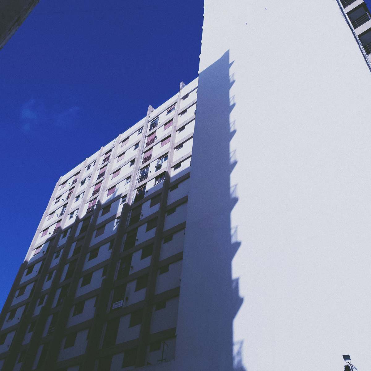 city low angle photography of high-rise building under clear sky high rise