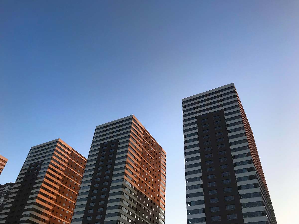 city low-angle photography of high-rise buildings under calm blue sky high rise