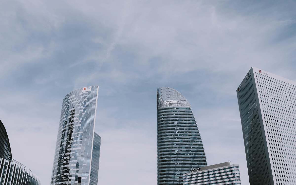 city low-angle photography of high-rise glass buildings grey