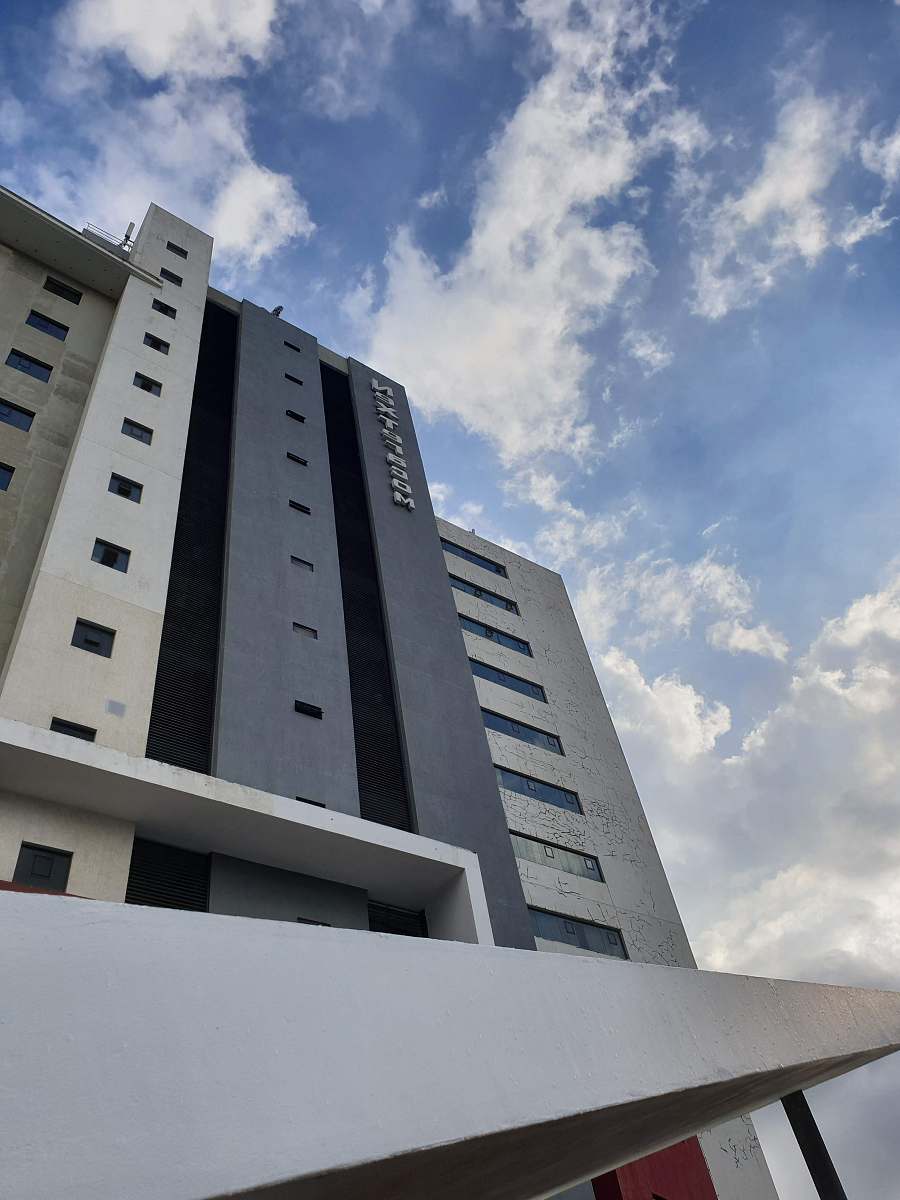 city low angle view of high rise building under cloudy day office building