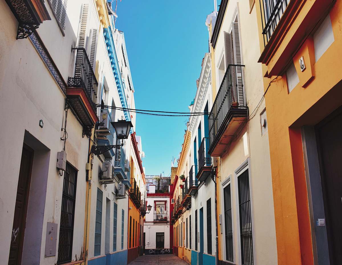 city pathway between buildings at daytime road