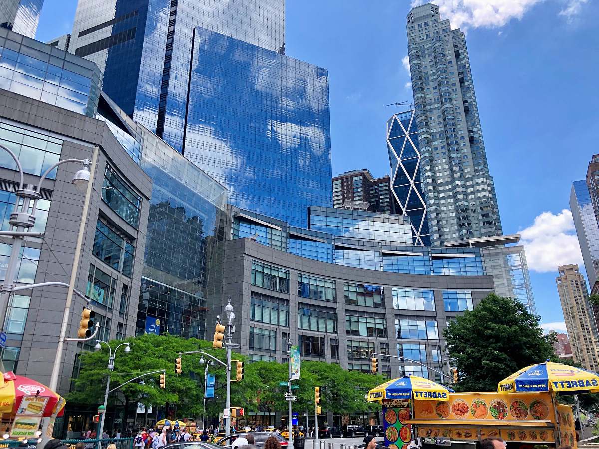 city people outside curtain wall buildings downtown