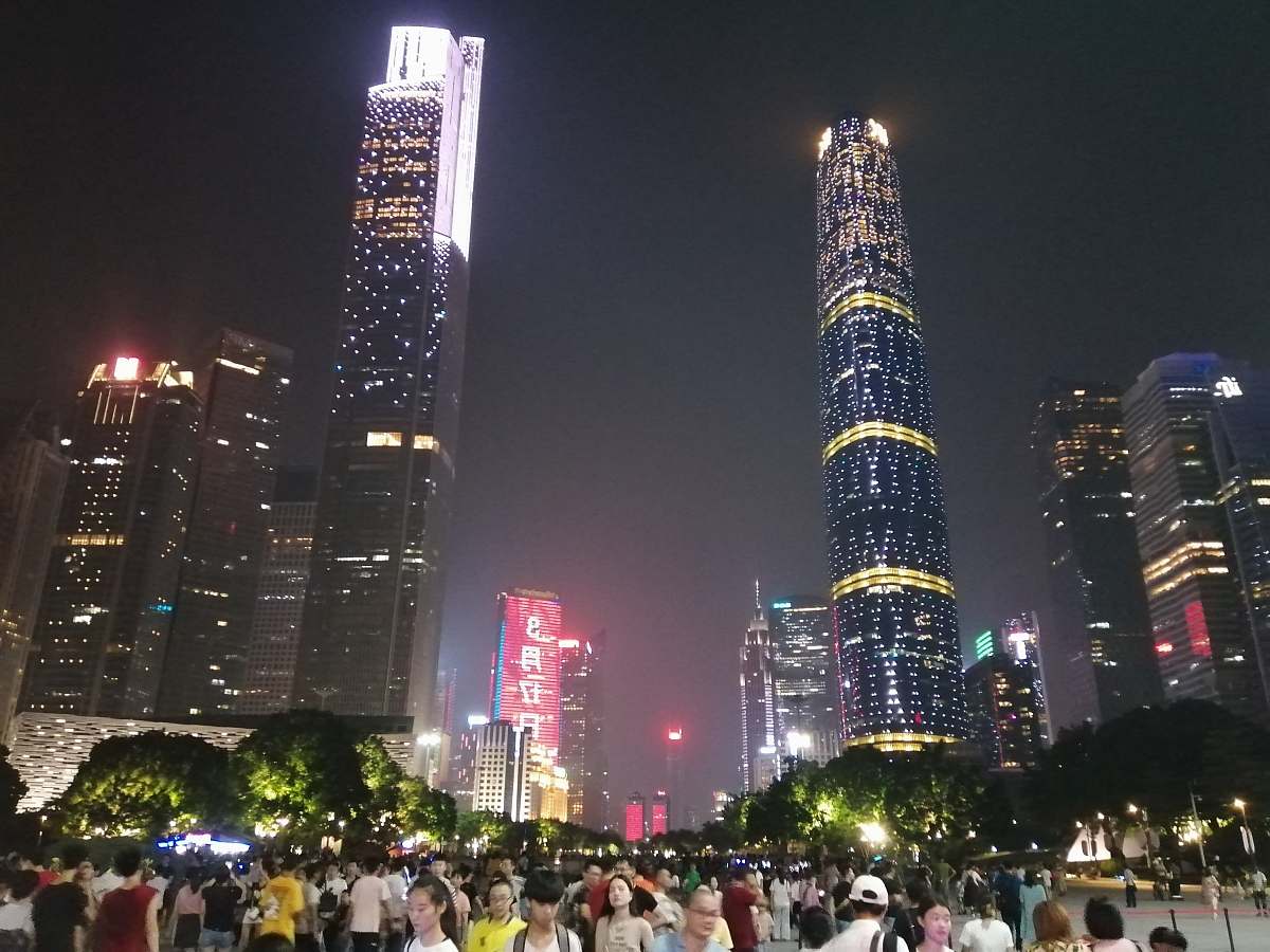 city people standing near buildings downtown